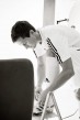 morten gamst pedersen in adidas outfit tying his shoe b&w